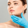 7 reasons why you should consider plastic surgery plastic surgeon touching face of attractive woman with marked face