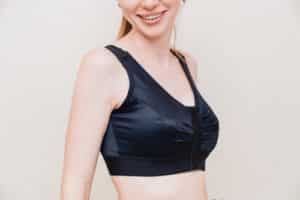 woman in black compression underwear after mammoplasty.